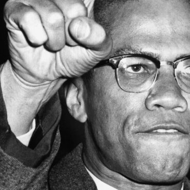 malcolm-x’s-legacy-60-years-later:-his-voice,-his-fight,-and-america’s-amnesia.
