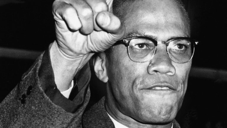 malcolm-x’s-legacy-60-years-later:-his-voice,-his-fight,-and-america’s-amnesia.